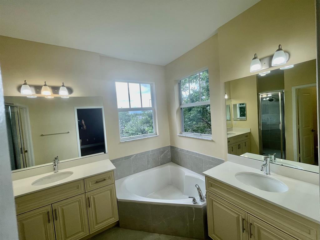 4803 Northwest 48th Terrace Tamarac, FL 33319 - Photo 15 of 28 a bathroom with a tub sink and mirror