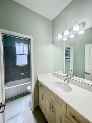 a bathroom with a sink a mirror and a bathtub