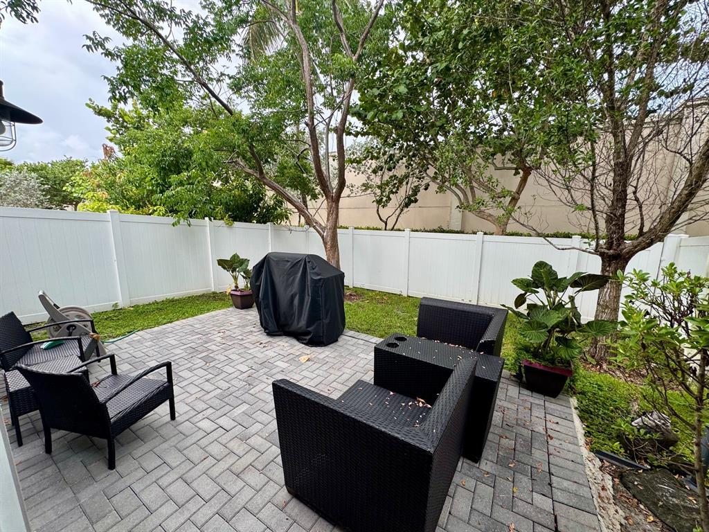 4803 Northwest 48th Terrace Tamarac, FL 33319 - Photo 24 of 28 a view of a backyard with furniture
