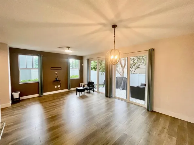 a view of a room with gym equipment and a large window