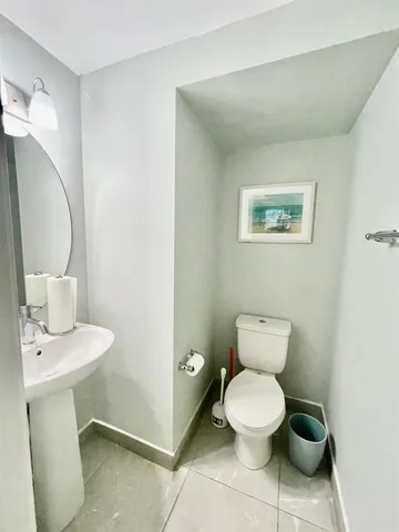 a bathroom with a toilet a sink and mirror