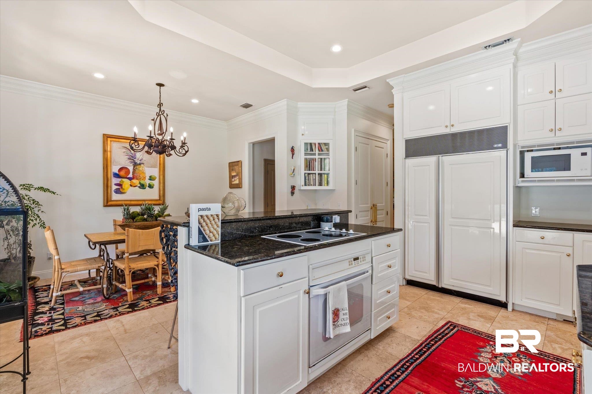6341 Raintree Road Fairhope, AL 36532 - Photo 9 of 40 Kitchen featuring light tile patterned flooring, built in appliances, a tray ceiling, and white cabinets