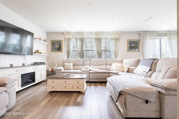 a living room with furniture and a flat screen tv
