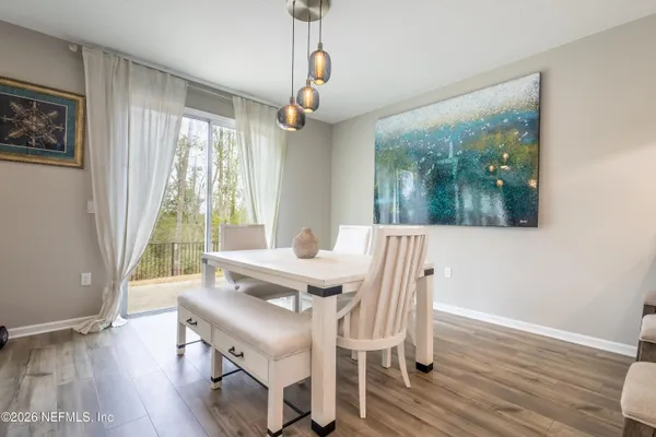 a view of a dining room with furniture window and wooden floor
