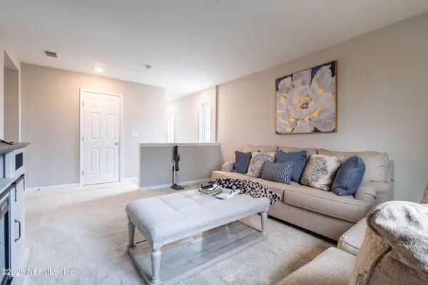 a living room with furniture and a large window