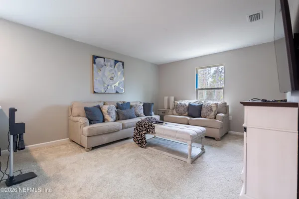 a living room with furniture and a window
