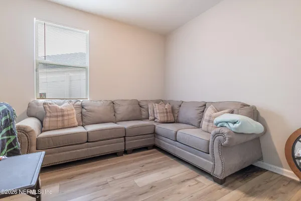 a living room with couches and a potted plant on coffee table