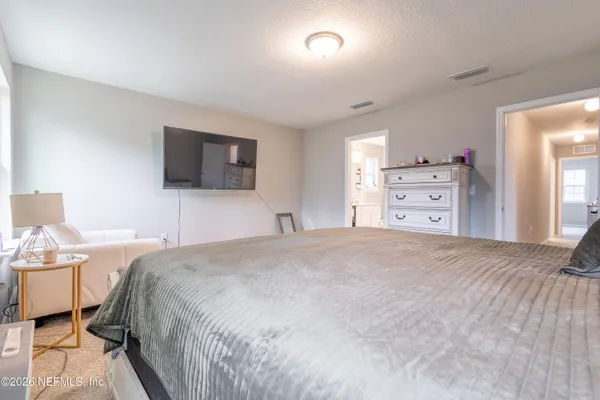 a bedroom with a bed and a tv