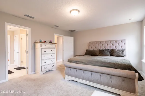 a bedroom with a bed and a closet