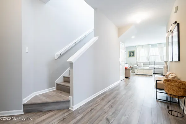 a view of a living room and entryway with wooden floor