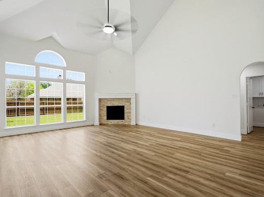 5034 West Fall Drive Midlothian, TX 76065 - Photo 11 of 40 Spacious living area featuring vaulted ceilings, wood-finish flooring, and a fireplace with a stone surround and white mantel