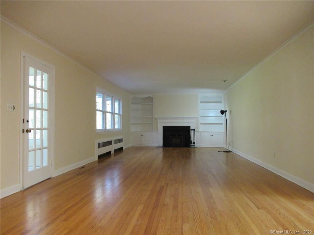 11 Burnt Swamp Road Woodbridge, CT 06525 - Photo 6 of 29 an empty room with wooden floor and fireplace