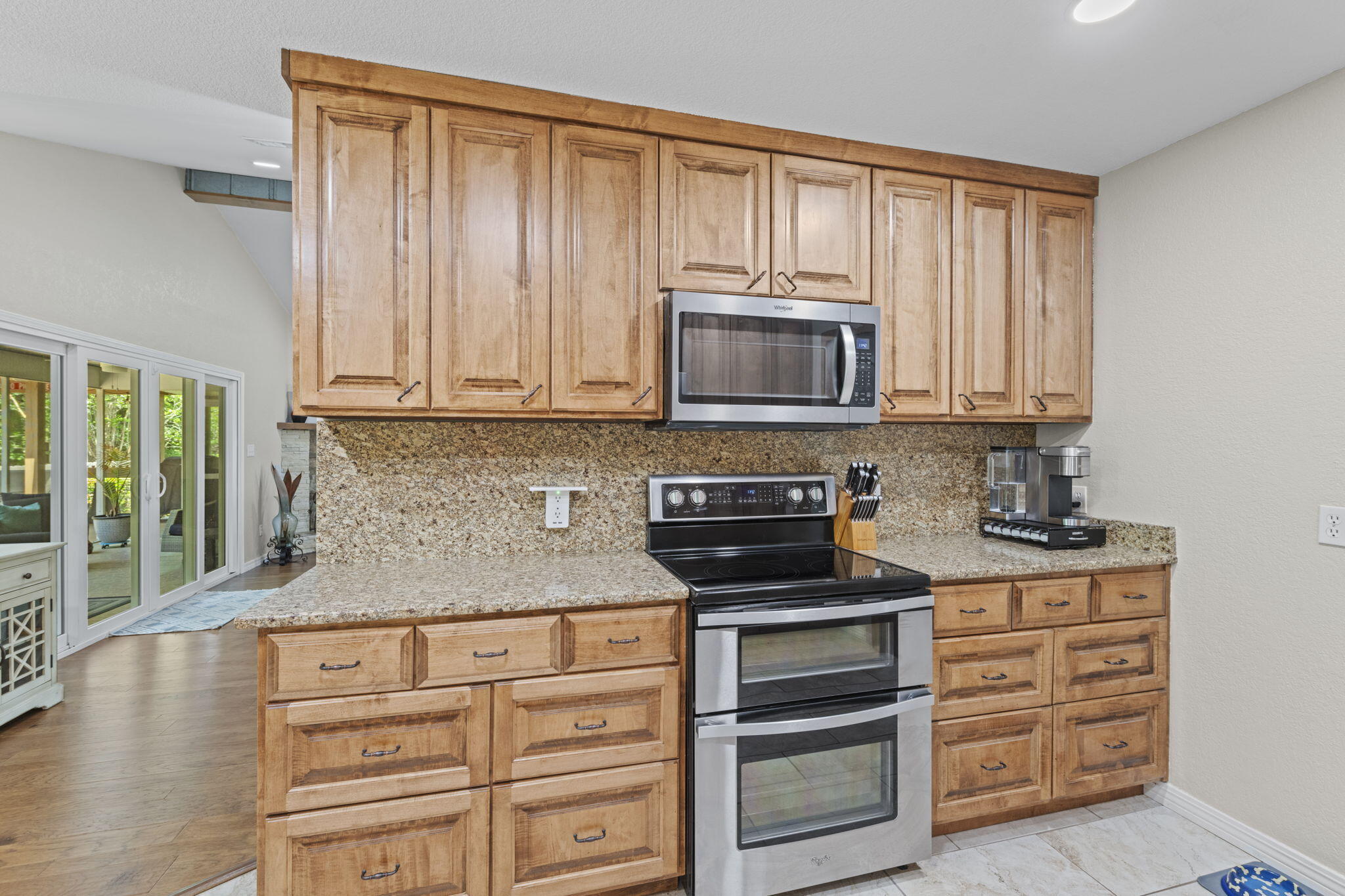 2519 Valley Road Navarre, FL 32566 - Photo 20 of 94 a kitchen with granite countertop a stove microwave and cabinets