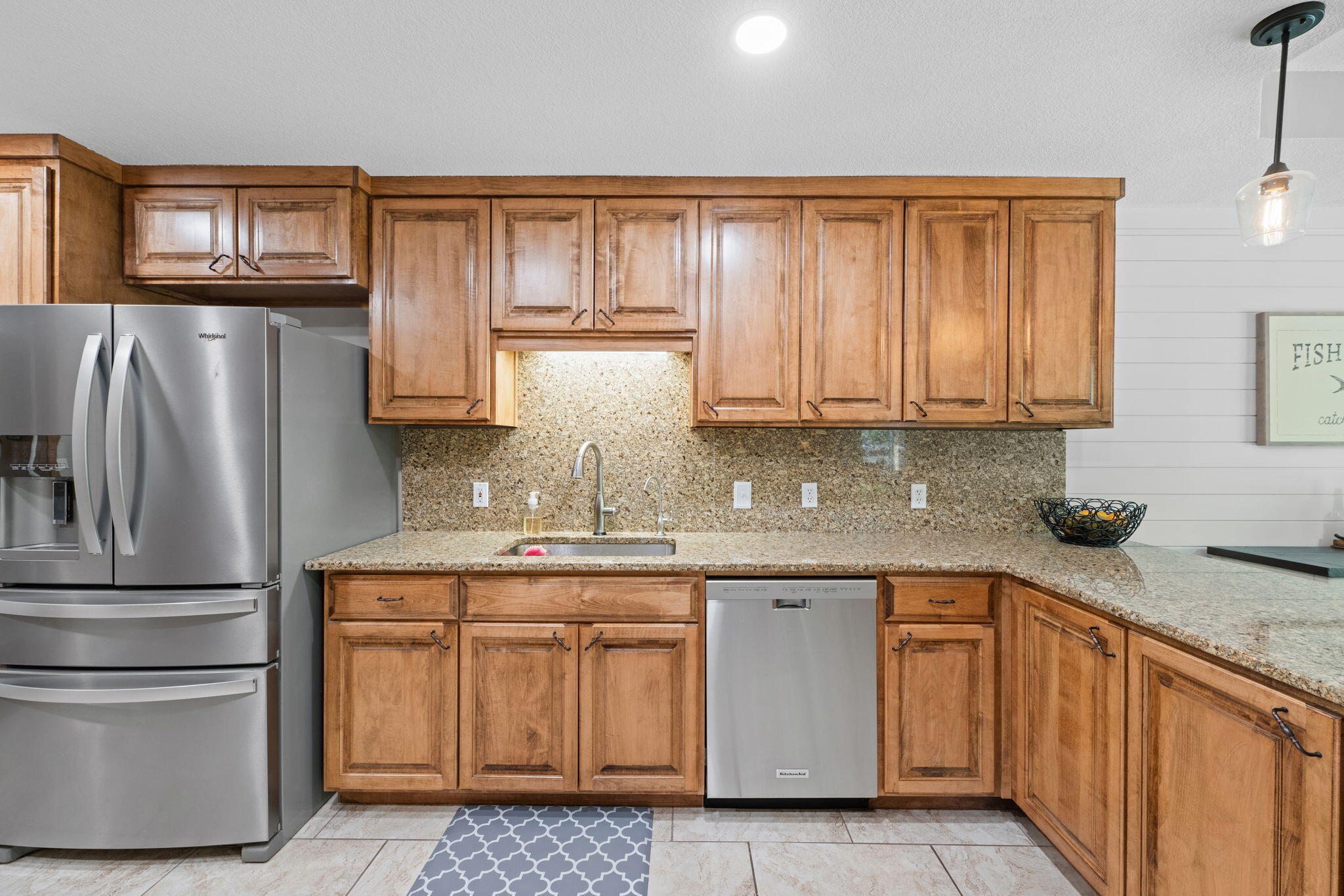 2519 Valley Road Navarre, FL 32566 - Photo 21 of 94 a kitchen with stainless steel appliances granite countertop a refrigerator sink and cabinets