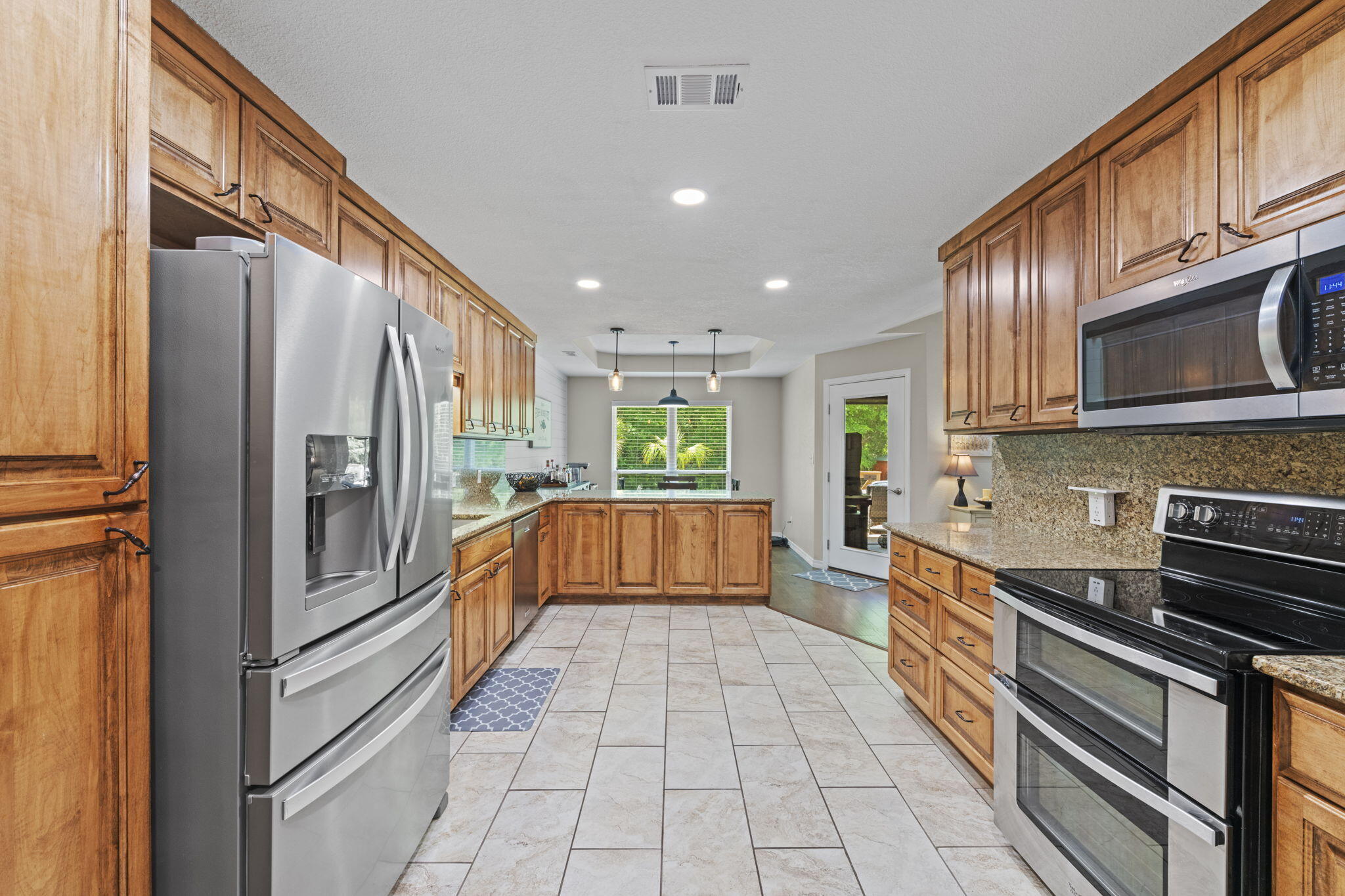 2519 Valley Road Navarre, FL 32566 - Photo 23 of 94 a kitchen with stainless steel appliances granite countertop a refrigerator and a stove top oven