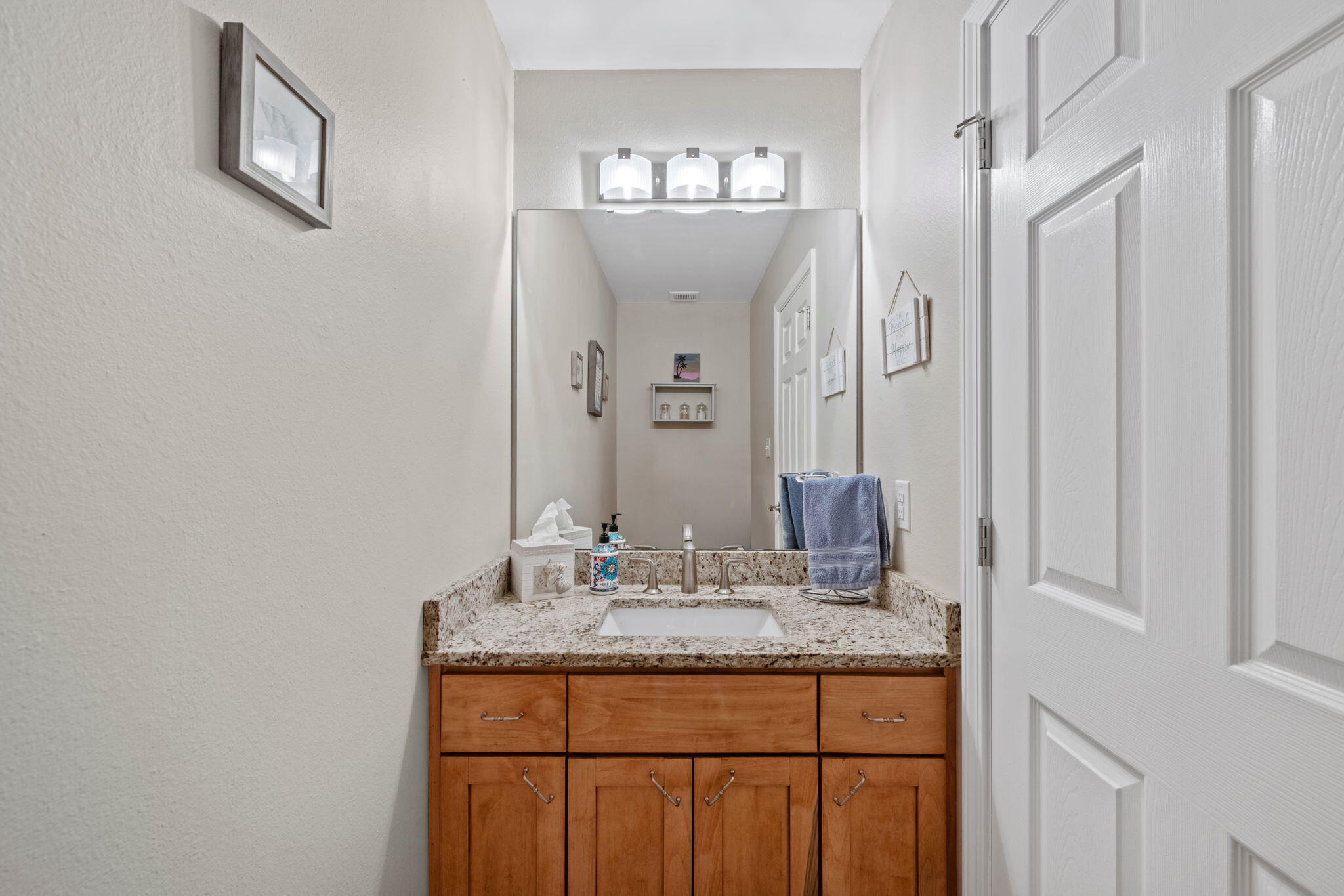 2519 Valley Road Navarre, FL 32566 - Photo 29 of 94 a bathroom with a granite countertop sink a mirror and a shower