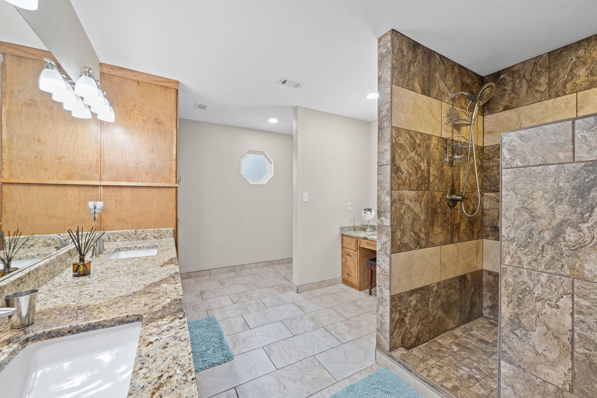 2519 Valley Road Navarre, FL 32566 - Photo 35 of 94 a bathroom with a granite countertop shower a sink and a mirror