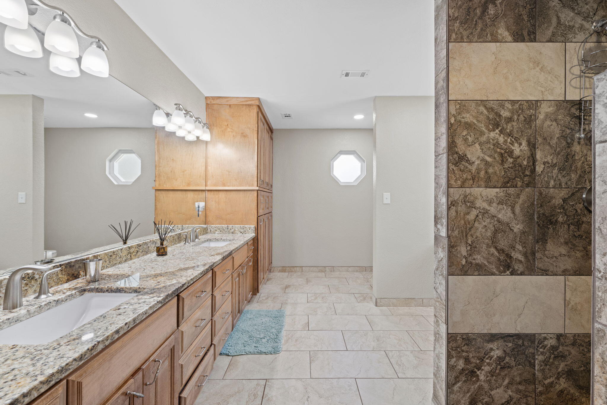 2519 Valley Road Navarre, FL 32566 - Photo 36 of 94 a bathroom with a granite countertop sink a mirror and a shower
