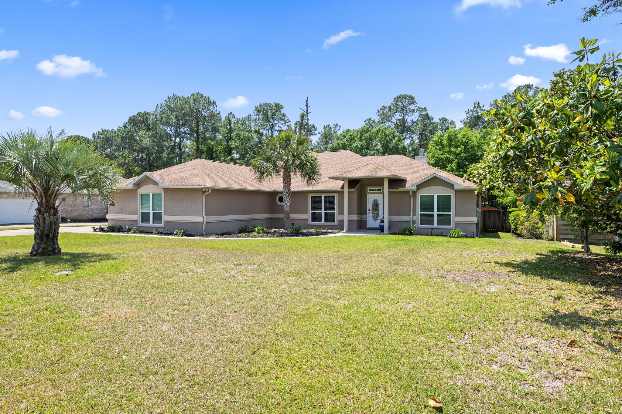 2519 Valley Road Navarre, FL 32566 - Photo 5 of 94 a front view of a house with garden space and swimming pool
