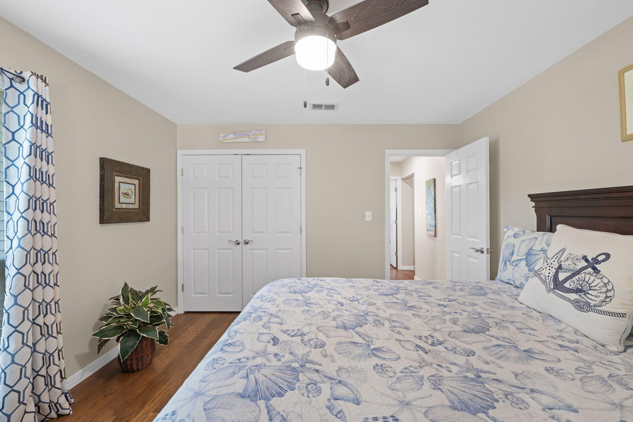 2519 Valley Road Navarre, FL 32566 - Photo 51 of 94 a bedroom with a large bed and a chandelier