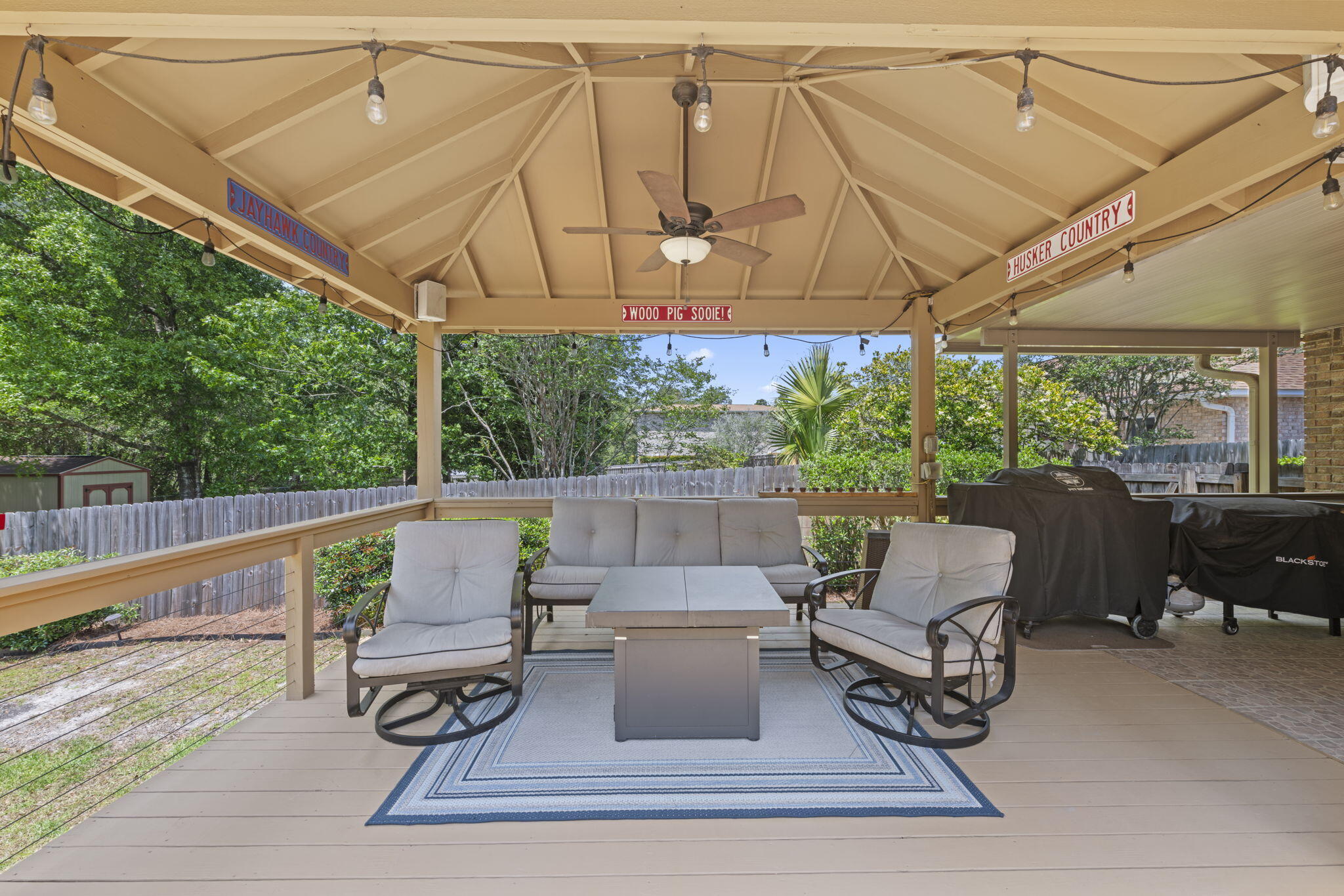 2519 Valley Road Navarre, FL 32566 - Photo 57 of 94 a view of a patio with table and chairs under an umbrella