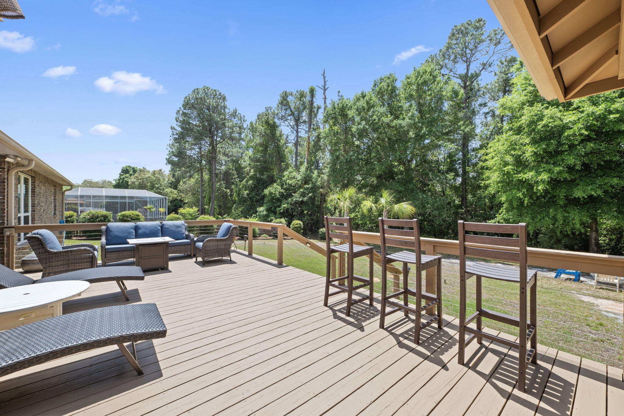 2519 Valley Road Navarre, FL 32566 - Photo 59 of 94 a view of a patio with dining table and chairs with wooden floor and fence