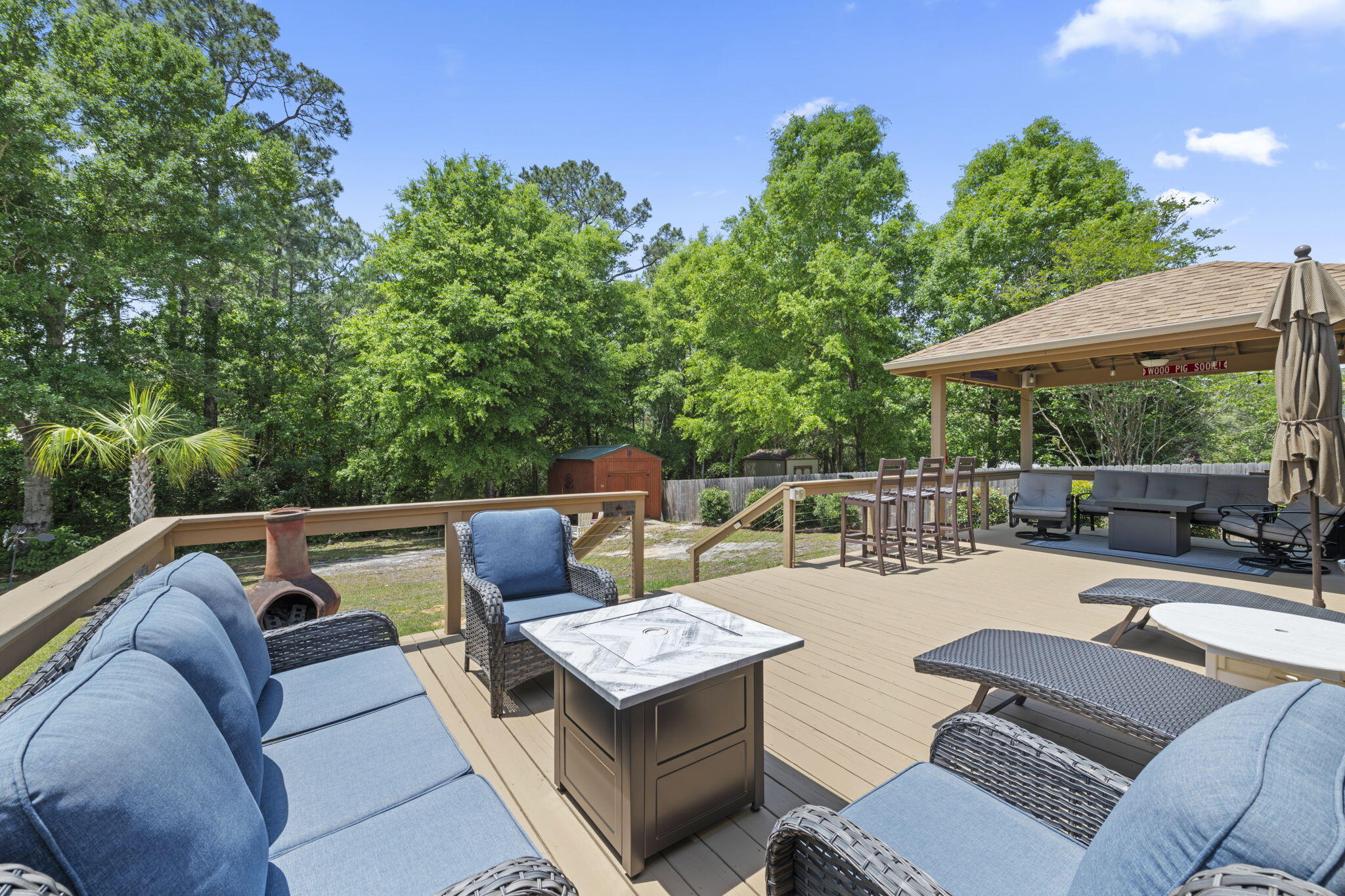2519 Valley Road Navarre, FL 32566 - Photo 60 of 94 a view of a patio with couches and a table and chairs with wooden fence