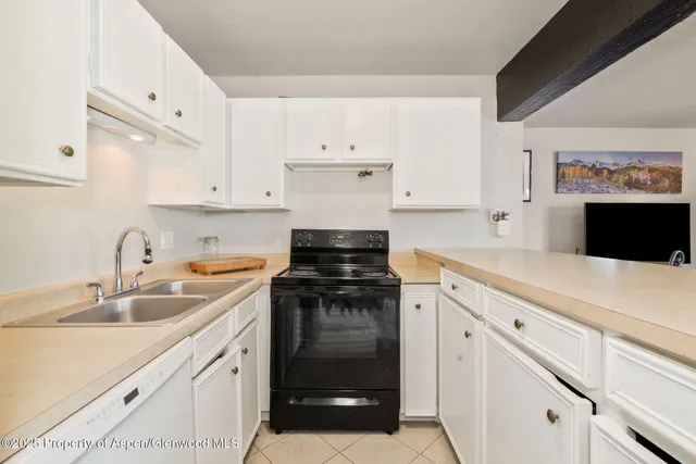 a view of a terrace with a bench and trees in the background