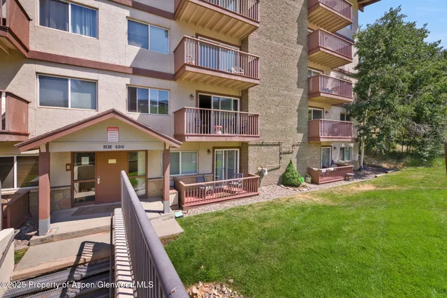 a view of a patio with table and chairs with wooden fence