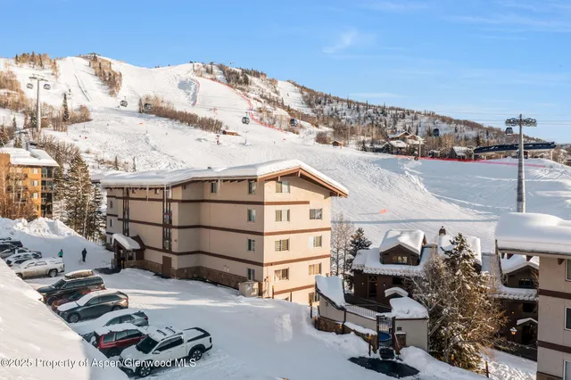 a kitchen with stove and wooden floor