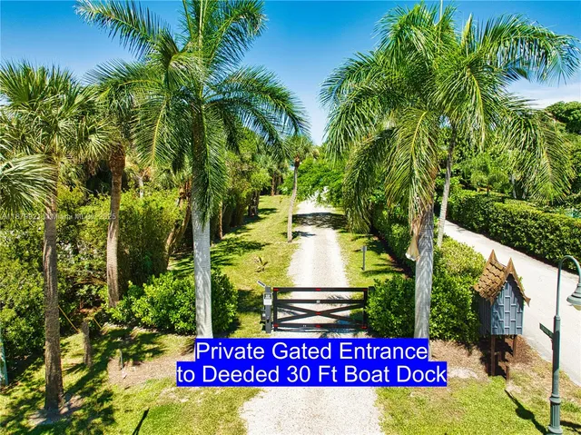 a sign that is sitting on a wooden bench in a garden