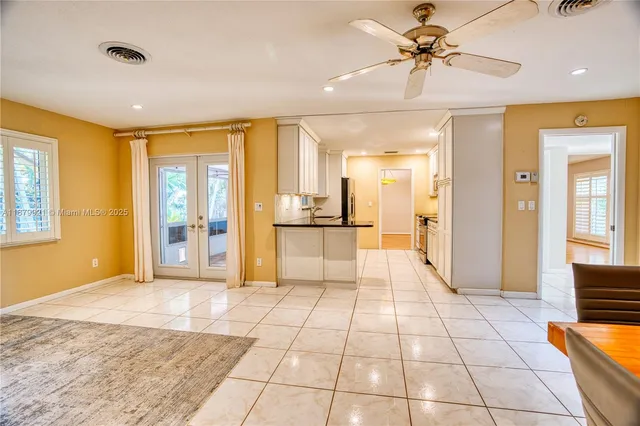 a view of a hallway with wooden floor and a living room