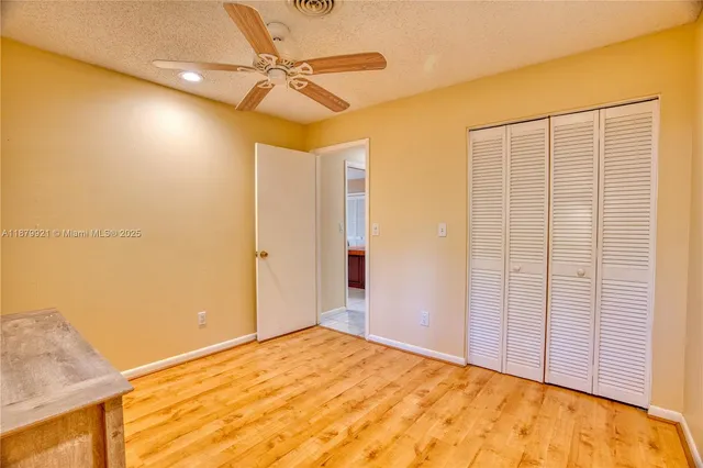 a view of a room with a ceiling fan