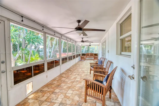 a view of a dining room with furniture water view and a floor to ceiling window