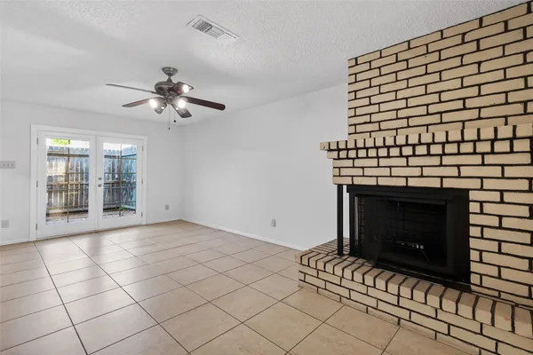 a view of an empty room with a fireplace