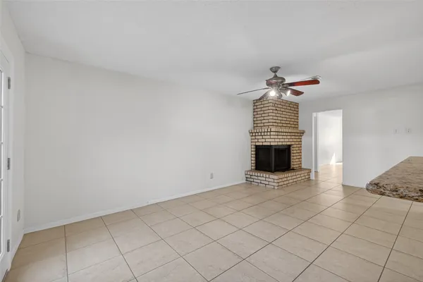 a view of an empty room with a fireplace