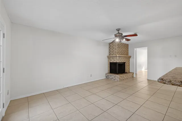 a view of an empty room with a fireplace