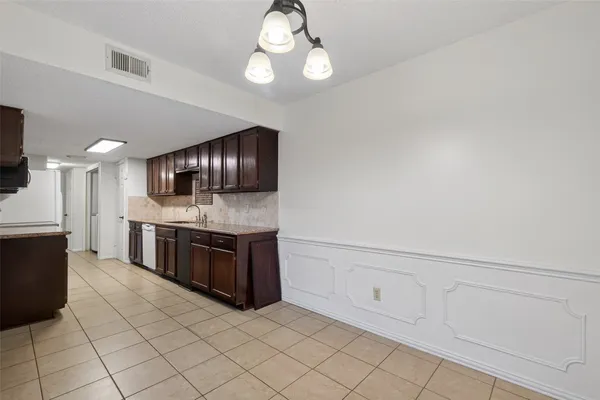 a large kitchen with cabinets and stainless steel appliances