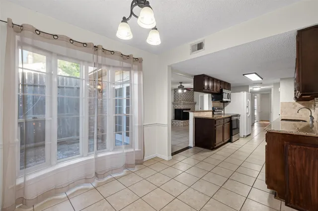 a large kitchen with cabinets and stainless steel appliances