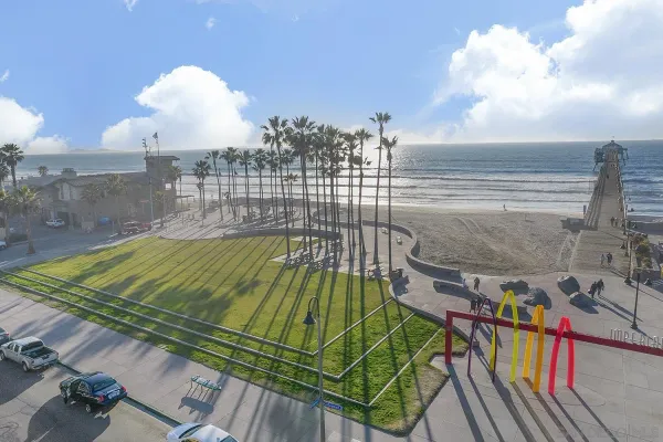 a view of roof deck with dining table and chairs