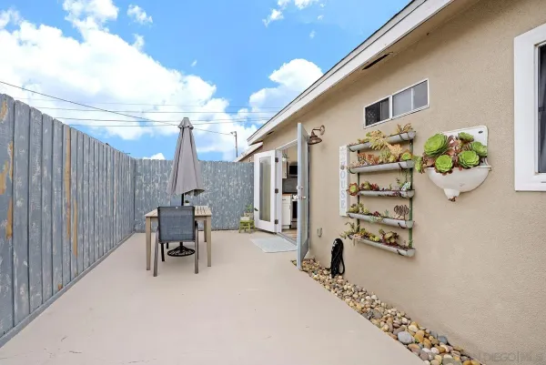 a kitchen with stainless steel appliances granite countertop a table chairs cabinets and wooden floor