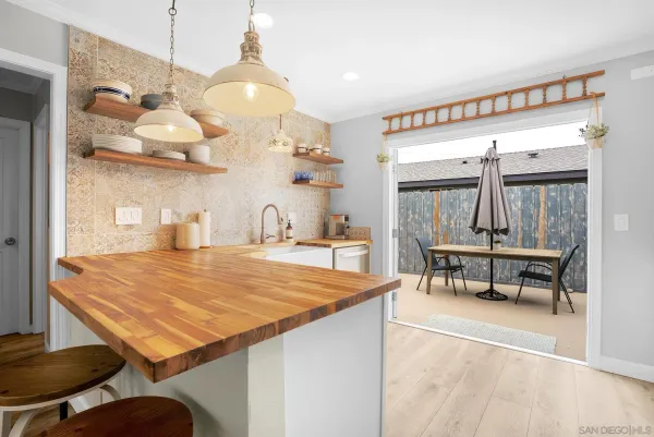 a kitchen with stainless steel appliances white cabinets and a refrigerator