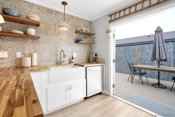 a dining room with furniture and a kitchen view