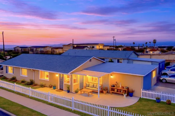 a view of a balcony with dining table and chairs