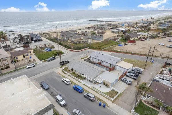 an aerial view of residential houses with outdoor space
