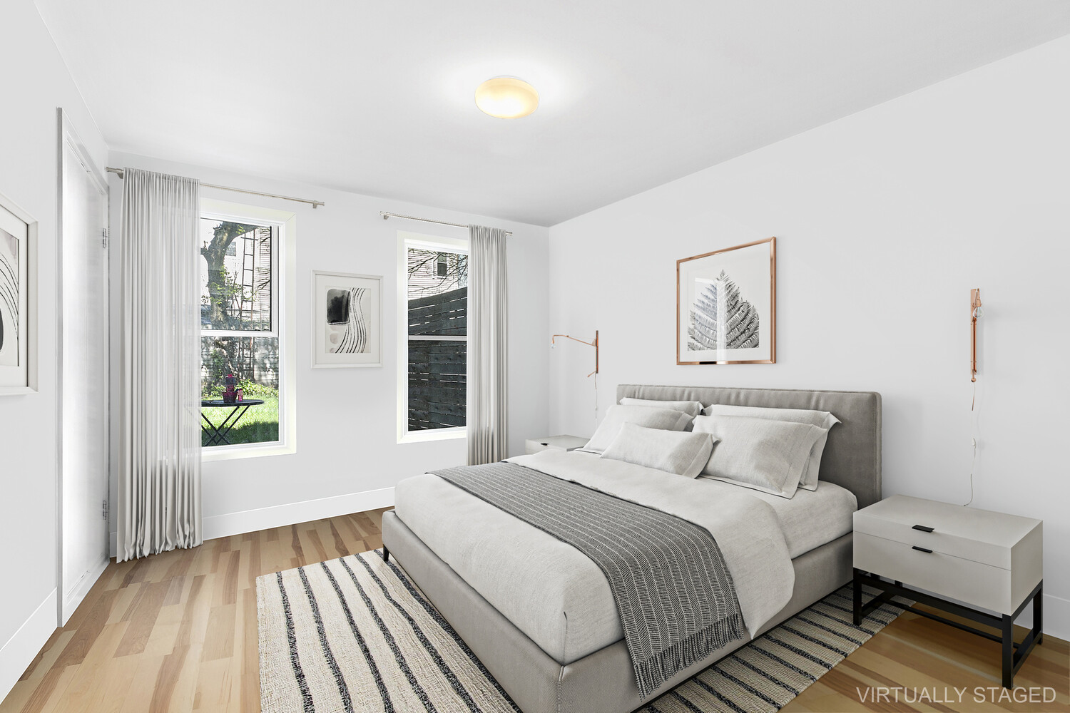 235 Covert Street Brooklyn, NY 11207 - Photo 13 of 15 a bedroom with a bed and a large window