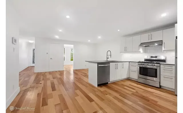 a kitchen with granite countertop a stove and a sink