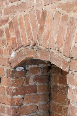 a city street lined with parked cars and buildings