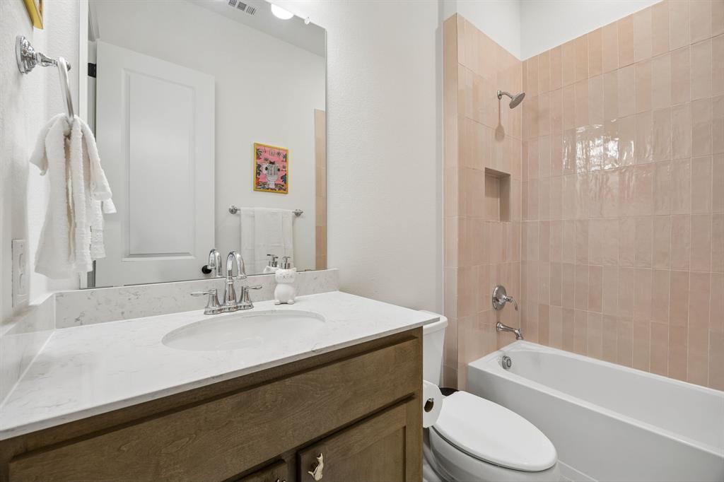 1717 Tolleson Drive Fort Worth, TX 76008 - Photo 25 of 40 a bathroom with a sink a toilet and a bathtub