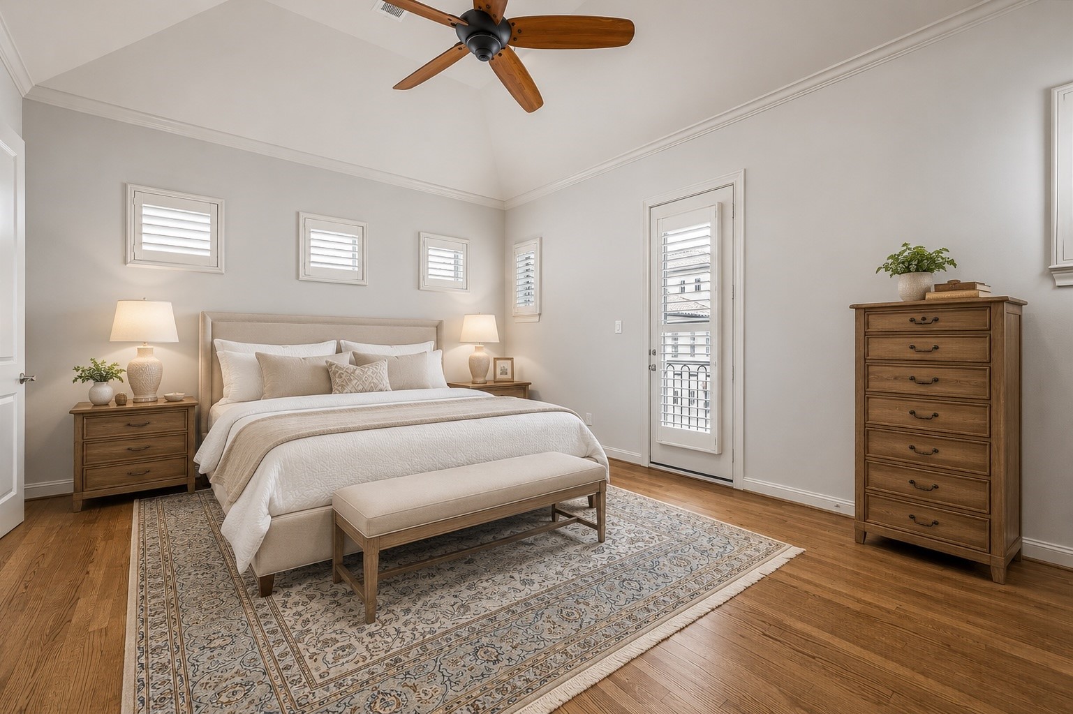 907 Queen Annes Road Houston, TX 77024 - Photo 10 of 31 Spacious primary suite with vaulted ceilings, hardwood flooring, abundant natural light, and private balcony access. This image has been virtually staged for illustrative purposes.